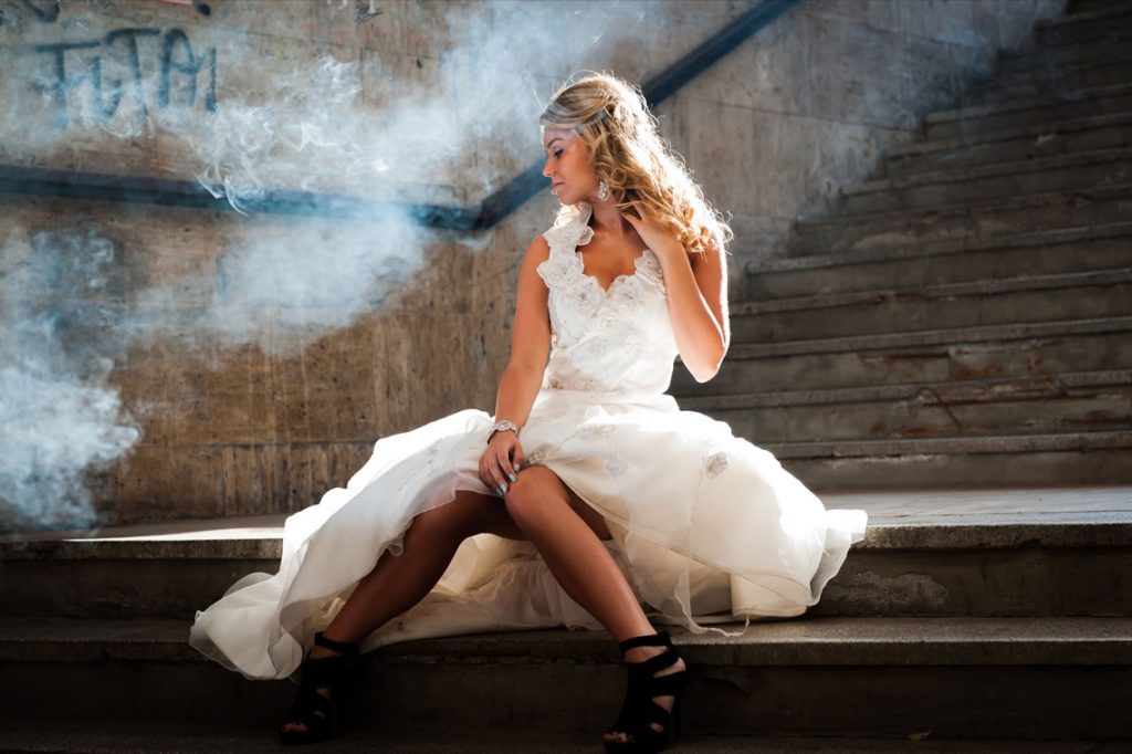 girl in white frock sitting in stairs