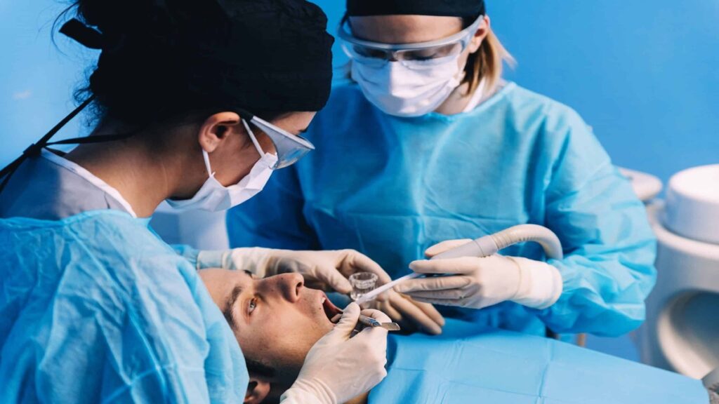 dentists-examining-male-patient-